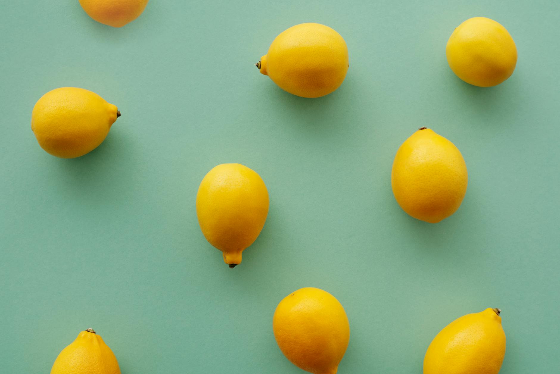 Bright yellow lemons on a soft green background, symbolizing fresh sensation and renewal